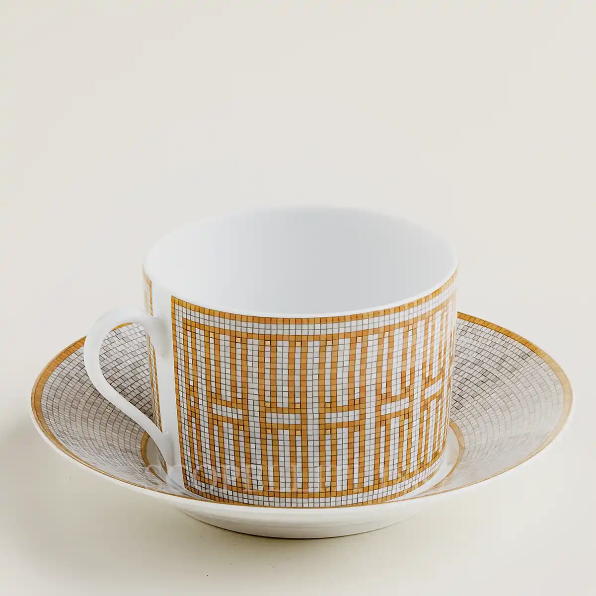 hermès mosaique au 24 breakfast cup and saucer with gold geometric mosaic pattern