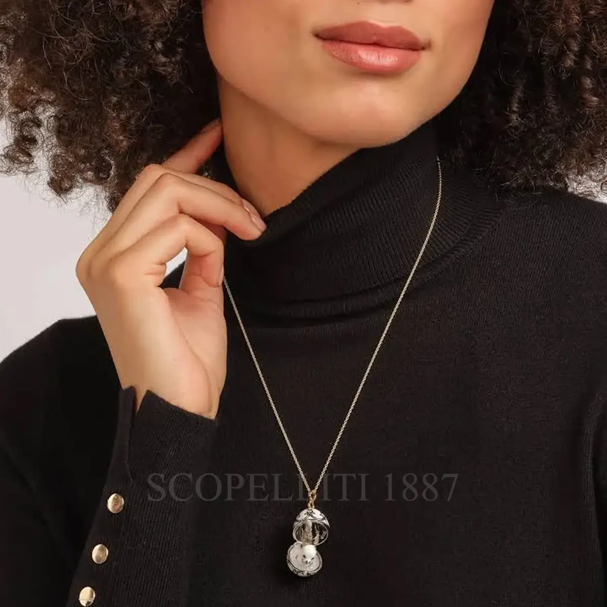 woman wearing fabergé seal surprise egg pendant