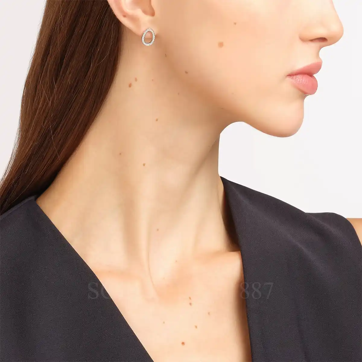 woman wearing fabergé sasha white gold diamond egg earrings