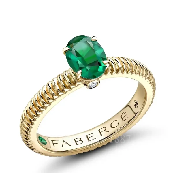 fabergé yellow gold solitaire ring with large emerald